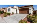 Charming home featuring a low-maintenance landscaped front yard and attached two-car garage at 21056 W Granada Rd, Buckeye, AZ 85396