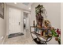 Inviting foyer featuring neutral tones, tile floors, and stylish decor, creating a warm welcome at 21056 W Granada Rd, Buckeye, AZ 85396