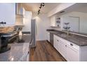 Updated kitchen with granite countertops, stainless steel appliances, and wood-look tile flooring at 2146 W Isabella Ave # 154, Mesa, AZ 85202