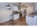 Updated kitchen features granite counters, stainless steel appliances, breakfast bar, and wood-look tile at 2146 W Isabella Ave # 154, Mesa, AZ 85202