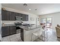 Modern kitchen features granite countertops, stainless steel appliances, and a breakfast bar at 21882 N 260Th Ln, Buckeye, AZ 85396