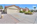 Desert landscaping and wide driveway complement this single-story home with a red tile roof at 2380 E Seville E Ct, Casa Grande, AZ 85194