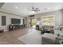 Spacious living room offers a comfortable sectional sofa, large television, and sliding doors leading to the pool at 2664 E Ebony Dr, Chandler, AZ 85286