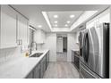 Modern kitchen featuring white cabinets, stainless steel appliances, and recessed lighting at 2927 W Glenn Dr, Phoenix, AZ 85051
