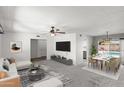 Bright open-concept living and dining area with view to the backyard pool at 2927 W Glenn Dr, Phoenix, AZ 85051