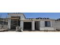 New home construction shows the exterior with a garage and scaffolding for adding finishing touches at 32139 N Lone Rancher Way, San Tan Valley, AZ 85140