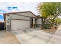 This lovely home features a two-car garage and charming desert landscaping, creating a welcoming exterior at 3219 W Pollack St, Phoenix, AZ 85041