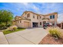 Spacious two-story home with a three car garage and a large driveway with desert landscaping at 3708 S 104Th Ln, Tolleson, AZ 85353