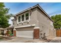 Side view of home with a spacious two-car garage, and nicely landscaped yard, with a brick accent at 3874 E Fruitvale Ave, Gilbert, AZ 85297