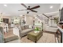 Bright living room featuring a modern staircase, stylish furniture, and an open layout leading to the kitchen at 3874 E Fruitvale Ave, Gilbert, AZ 85297