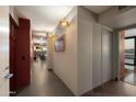Elegant hallway features stylish lighting, a cherry wood storage unit, and easy access to living areas at 4808 N 24Th St # 1424, Phoenix, AZ 85016