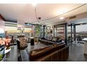 Bright living room with floor-to-ceiling windows offering city views and stylish modern furniture at 4808 N 24Th St # 1424, Phoenix, AZ 85016