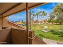 Balcony overlooking the community, featuring lush green lawns, mature trees, and picnic areas at 4901 S Calle Los Cerros Dr # 219, Tempe, AZ 85282
