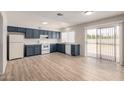 Spacious kitchen features abundant cabinetry, modern appliances, and sliding glass door with backyard access at 508 W Pampa Ave, Mesa, AZ 85210