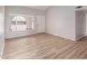 Bright living room features laminate flooring and neutral walls, creating a welcoming and modern space at 508 W Pampa Ave, Mesa, AZ 85210