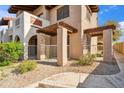Condo exterior view showcasing a cozy gated patio area and beautiful desert landscaping at 5757 W Eugie Ave # 1080, Glendale, AZ 85304