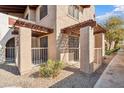 Condo exterior view showcasing a cozy gated patio area and beautiful desert landscaping at 5757 W Eugie Ave # 1080, Glendale, AZ 85304