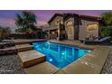 Stunning pool in backyard oasis with steps, lighting and plenty of space for relaxation and fun at 639 N 110Th Pl, Mesa, AZ 85207
