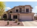 Charming two-story home with a two-car garage, desert landscaping, and a welcoming entrance at 639 N 110Th Pl, Mesa, AZ 85207