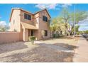Charming two-story house features a well-manicured front yard with low-maintenance desert landscaping and walkway at 6811 W Aire Libre Ave, Peoria, AZ 85382