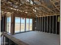 An unfinished living room shows the frame and sliding glass doors ready for the next phase of construction at 7707 W Avenida Del Rey --, Peoria, AZ 85383