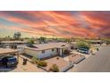 Well-maintained home features desert landscaping, a covered porch, and a side carport for additional parking at 809 N 95Th St, Mesa, AZ 85207