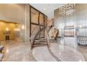 Grand lobby with a curved staircase, modern chandelier, and elevator access at 945 E Playa Del Norte Dr # 4017, Tempe, AZ 85288