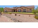 Charming home with desert landscaping, rock accents, and a well-maintained front yard at 9625 W Prospector Dr, Queen Creek, AZ 85144