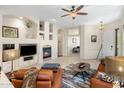 Comfortable living room with a fireplace and open floor plan at 9653 E Sidewinder Trl, Scottsdale, AZ 85262