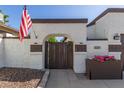 Inviting gated front entry featuring a walkway, accent lighting and desert landscaping at 1029 E Marco Polo Rd, Phoenix, AZ 85024