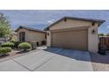 Charming single-Gathering home showcasing a well-maintained two-car garage and desert landscaping at 1197 W Fir Tree Rd, Queen Creek, AZ 85140