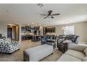 Open-concept interior showcases tile floors, a ceiling fan, and seamless flow into the kitchen at 1197 W Fir Tree Rd, Queen Creek, AZ 85140