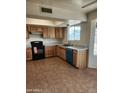 Well-lit kitchen featuring ceramic tile flooring, light wood cabinetry, and modern appliances at 124 S Cottonwood St, Chandler, AZ 85225