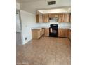 Spacious kitchen with light wood cabinets, white countertops, and black appliances at 124 S Cottonwood St, Chandler, AZ 85225