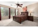 Serene main bedroom with large windows, soft carpet, and stylish furniture, offering a relaxing retreat at 13051 W Black Hill Rd, Peoria, AZ 85383