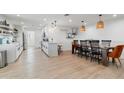 Modern open concept shows kitchen and dining space with sleek white cabinets and an island at 1307 E Encanto St, Mesa, AZ 85203