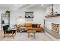Inviting living room with a charming brick fireplace, plush seating, and decorative rug at 1307 E Encanto St, Mesa, AZ 85203