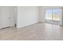 Bright living room with tile floors and access to the backyard through sliding glass doors at 1331 W Hess Ave, Coolidge, AZ 85128