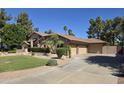 Charming home exterior featuring desert landscaping and a spacious driveway at 1348 E Los Arboles Dr, Tempe, AZ 85284