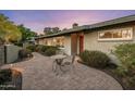 Beautifully landscaped front yard with a quaint table set, showcasing the home's curb appeal at 13631 N Canterbury Dr, Phoenix, AZ 85023