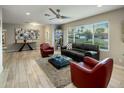 Bright living room featuring neutral tones, a ceiling fan, and large windows at 13631 N Canterbury Dr, Phoenix, AZ 85023