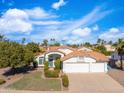 Charming single-story home with a well-manicured lawn and a two car garage in a sunny neighborhood at 14241 N 56Th Pl, Scottsdale, AZ 85254