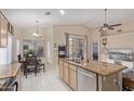 Open kitchen and dining area boasts an island with sink and granite countertops and stainless steel appliances at 17128 E Kensington Pl, Fountain Hills, AZ 85268