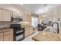 Charming kitchen with stainless steel microwave and double oven, granite countertops, and eat-in dining area at 17128 E Kensington Pl, Fountain Hills, AZ 85268