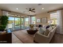 Sunlit living room featuring a large sliding glass door to the outdoor patio at 17656 W Bajada Rd, Surprise, AZ 85387