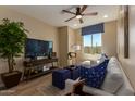 Cozy living room featuring wood-look tile flooring and lots of natural light at 17656 W Bajada Rd, Surprise, AZ 85387