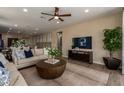 Bright living room features a ceiling fan, recessed lighting, and an open floor plan at 17656 W Bajada Rd, Surprise, AZ 85387