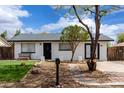 Charming home featuring black and white paint, modern design, and well-kept landscaping at 1985 S Plaza Dr, Apache Junction, AZ 85120