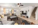 Bright living room showcasing a large sectional sofa, neutral decor, and staircase at 2167 S Luther Ave, Mesa, AZ 85209