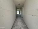 Hallway featuring smooth grey concrete flooring and grey unfinished walls at 2356 E Spur Dr, San Tan Valley, AZ 85140